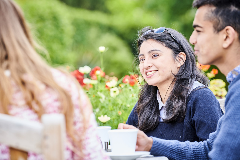 Students chatting at table in the Botanic Gardens
