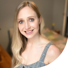 A woman with longer blonde hair smiling at the camera.