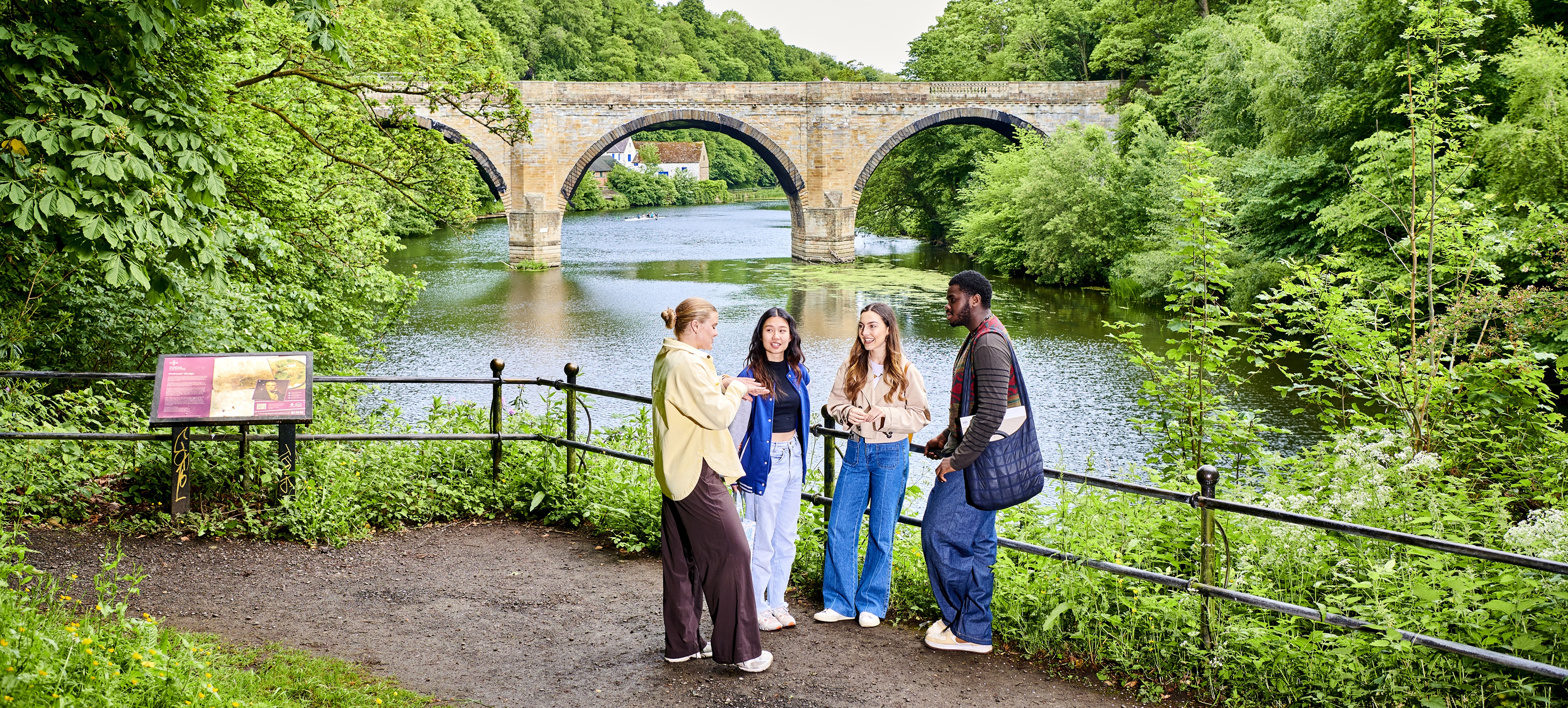 Group of four students in front of Prebends Bridge in Durham.