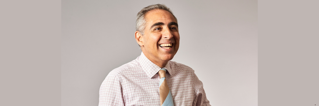 Professor Anoush Ehteshami smiling and looking off camera, in front of a pale grey background