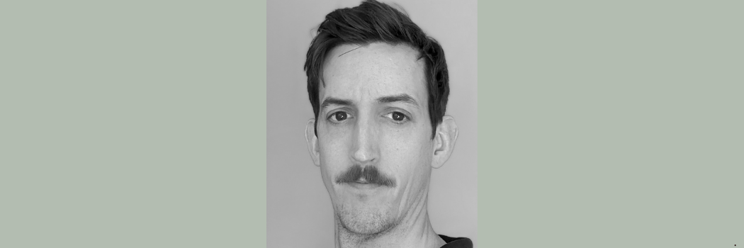 A black and white image of Professor Michael Magee facing the camera