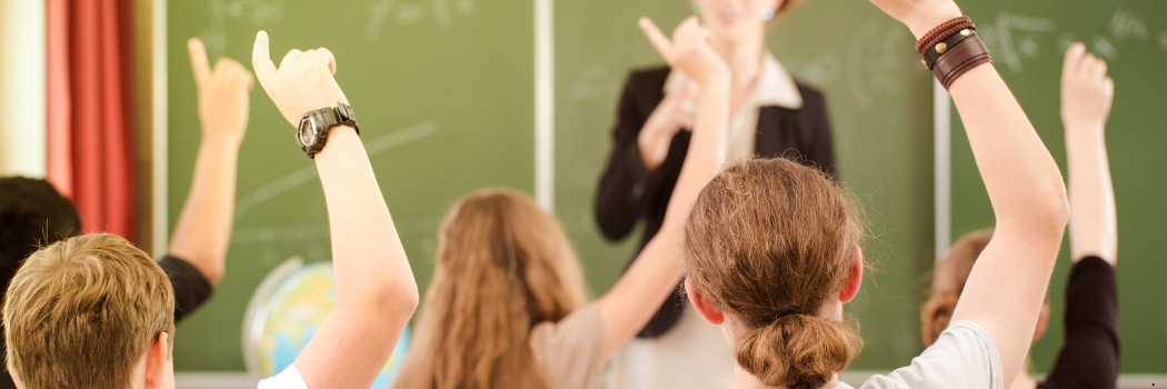 School children in a classroom with a teacher