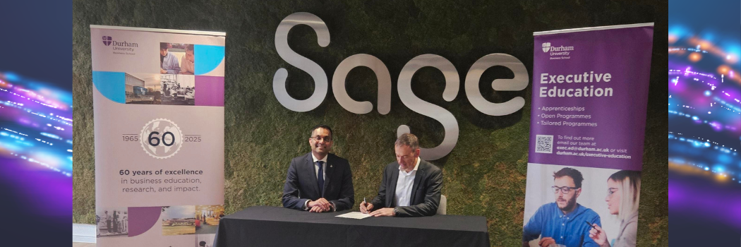 Agreement signing in front of Sage and Durham University logos