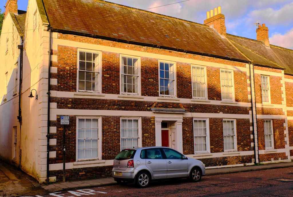 Front View of Hallgarth House - a Georgian building - with a car parked outside