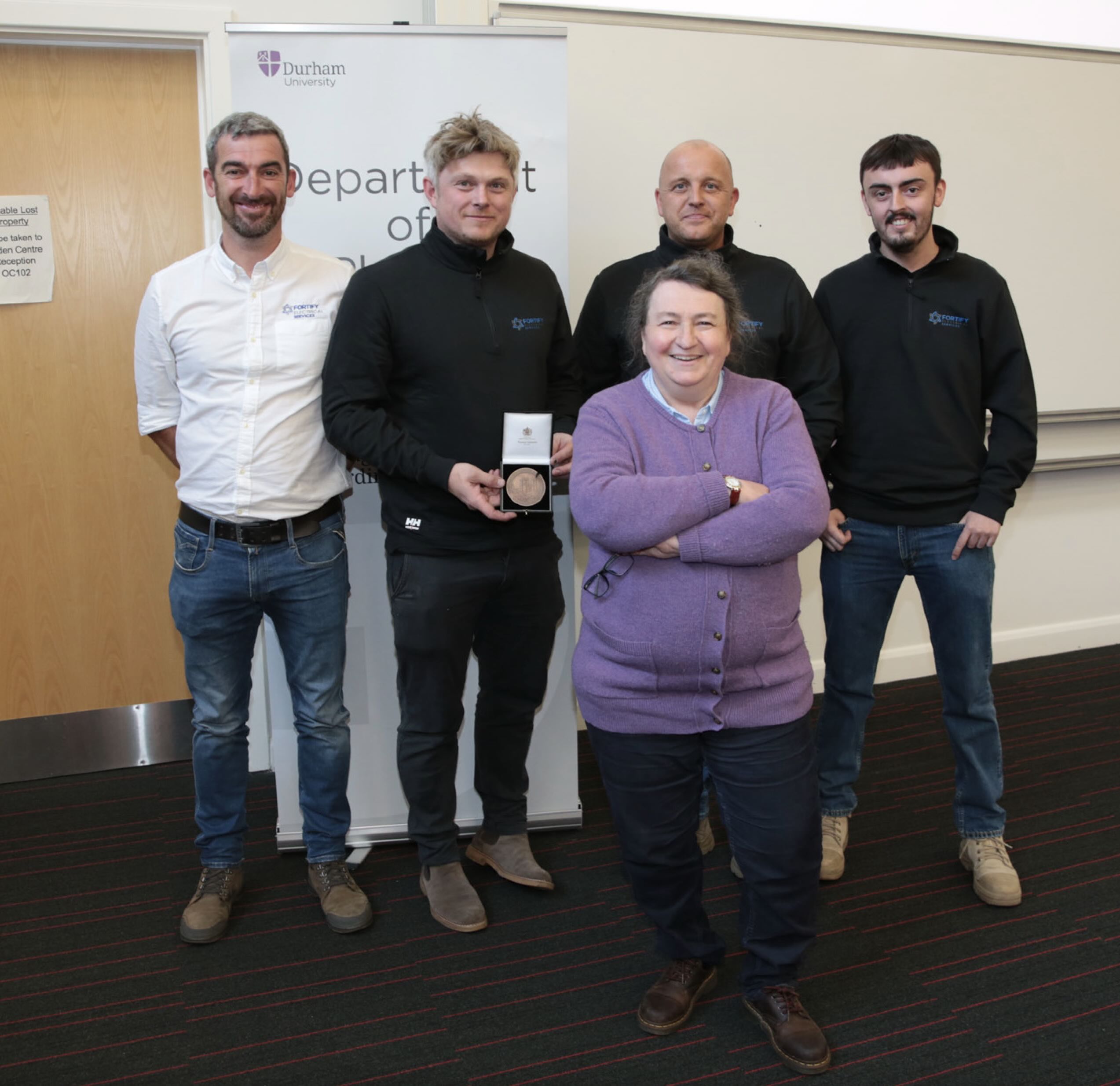 Group photo, workers from Fortify electrical services with Prof Paula Chadwick