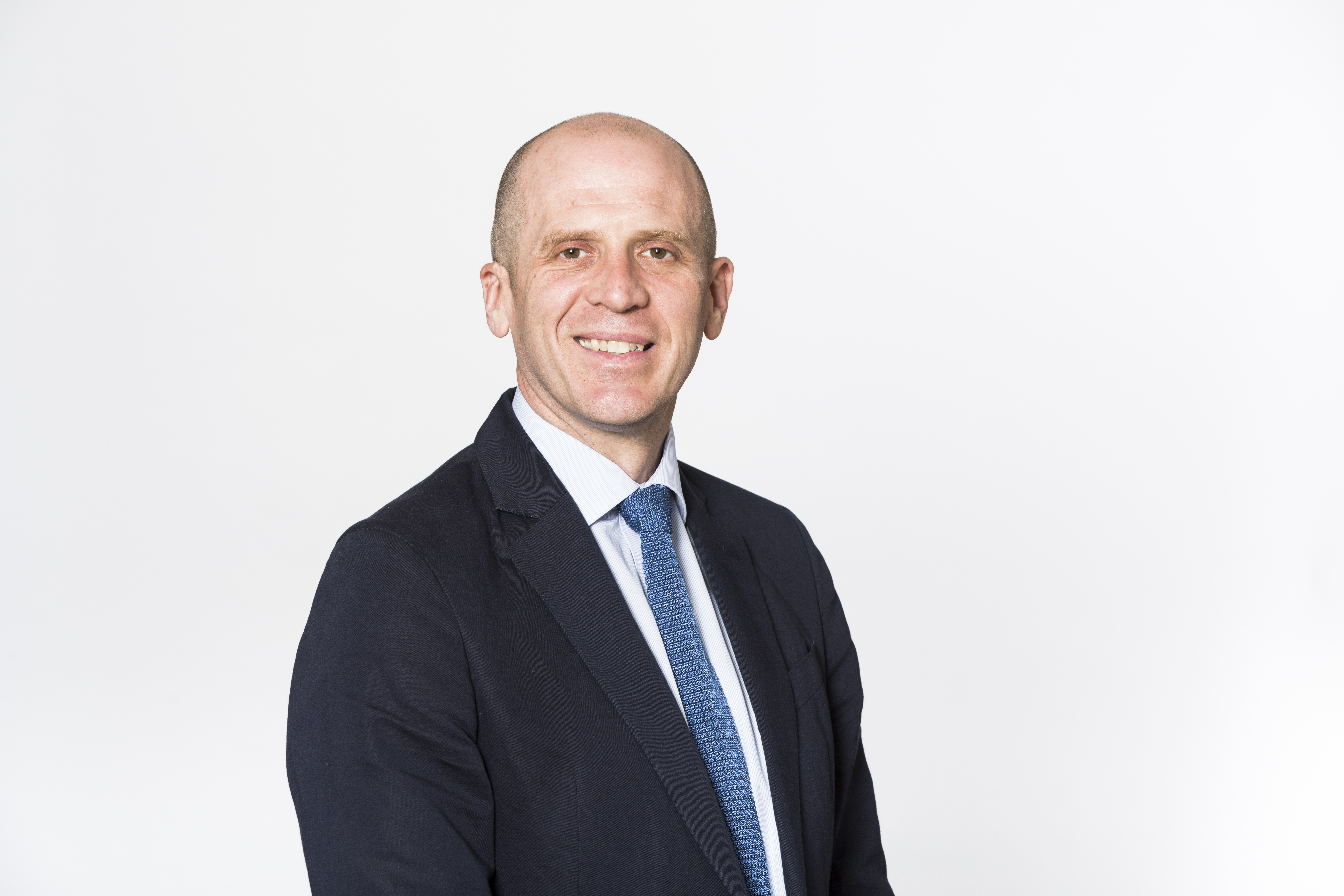 A man smiling with a white background