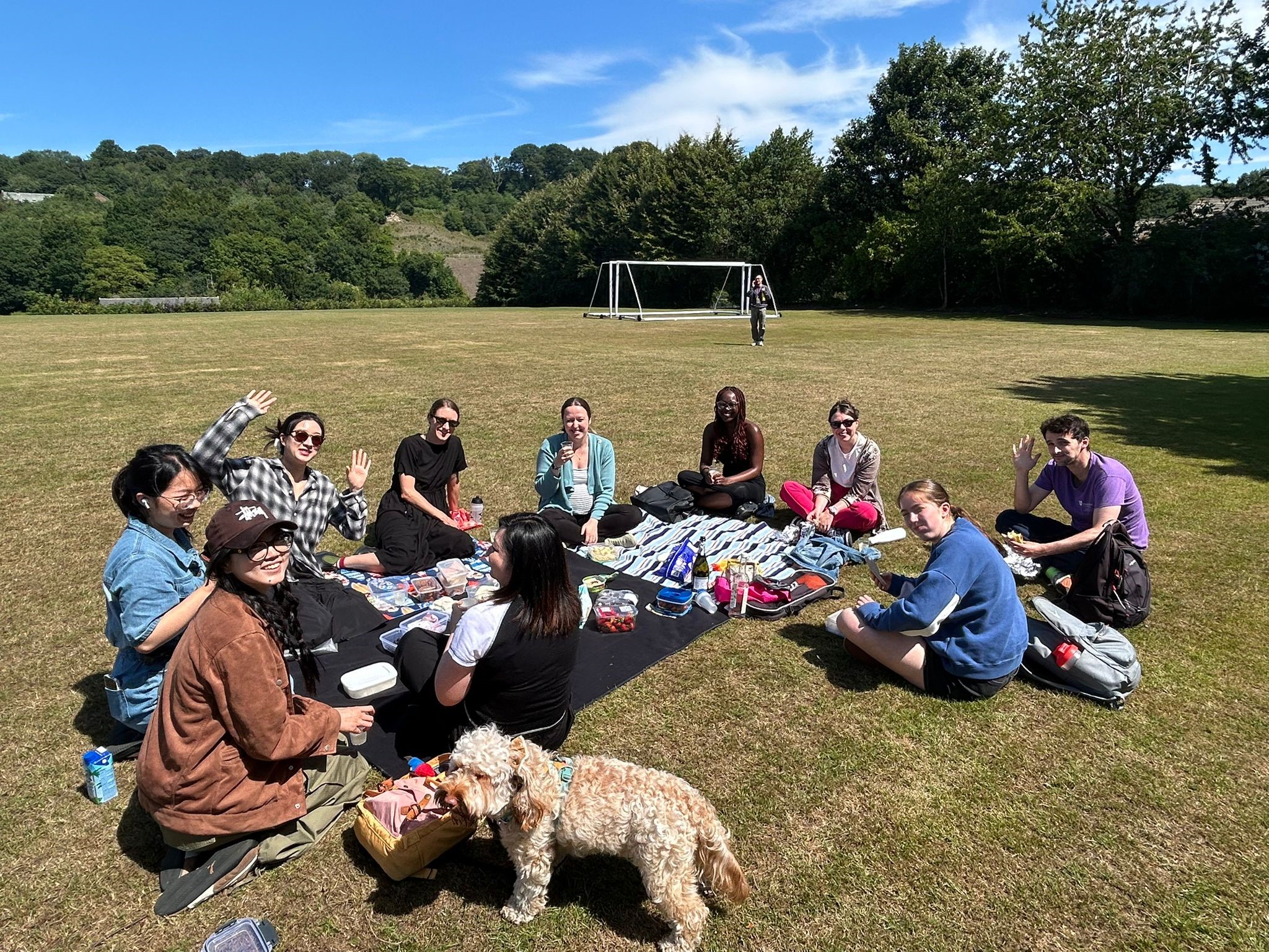 PGR Community sitting on a picnic blanket sharing food