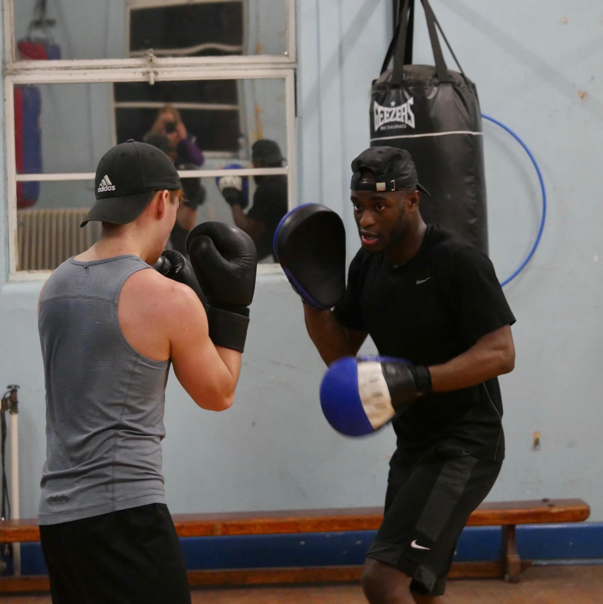Two boxers practising boxing