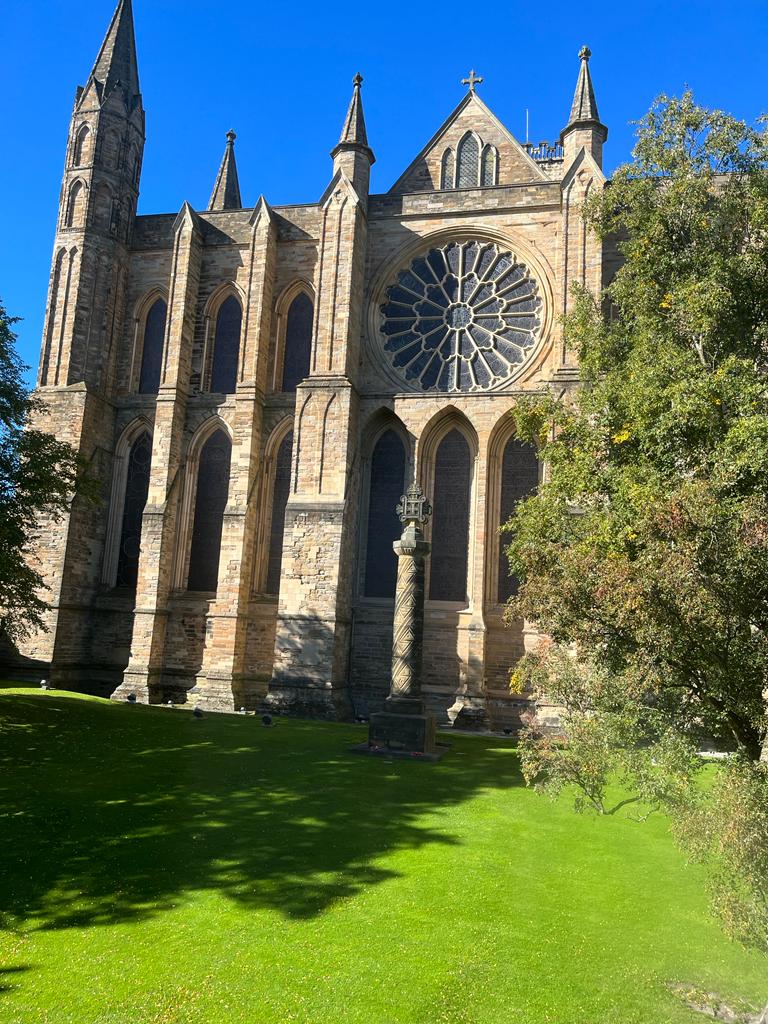 A view of Durham Cathedral from the outside on a clear, sunny day.