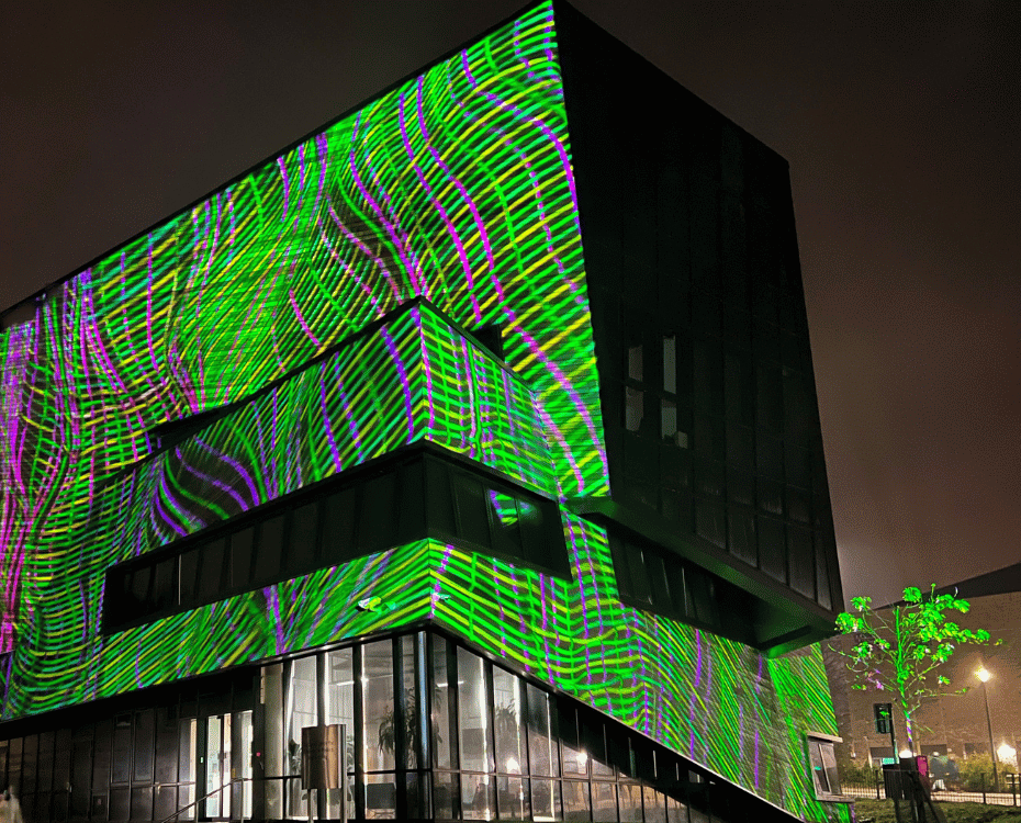 The Ogden Centre illuminated with green and pink artwork