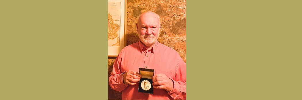 David Harper is pictured against a brick wall carrying the Lapworth Medal