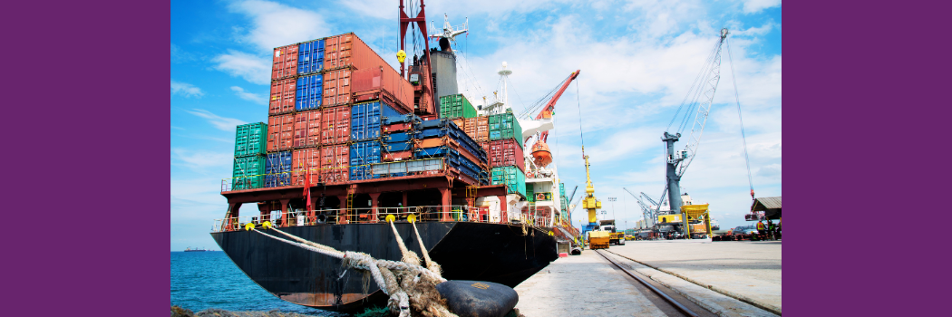 A transport ship carries shipping containers full of goods