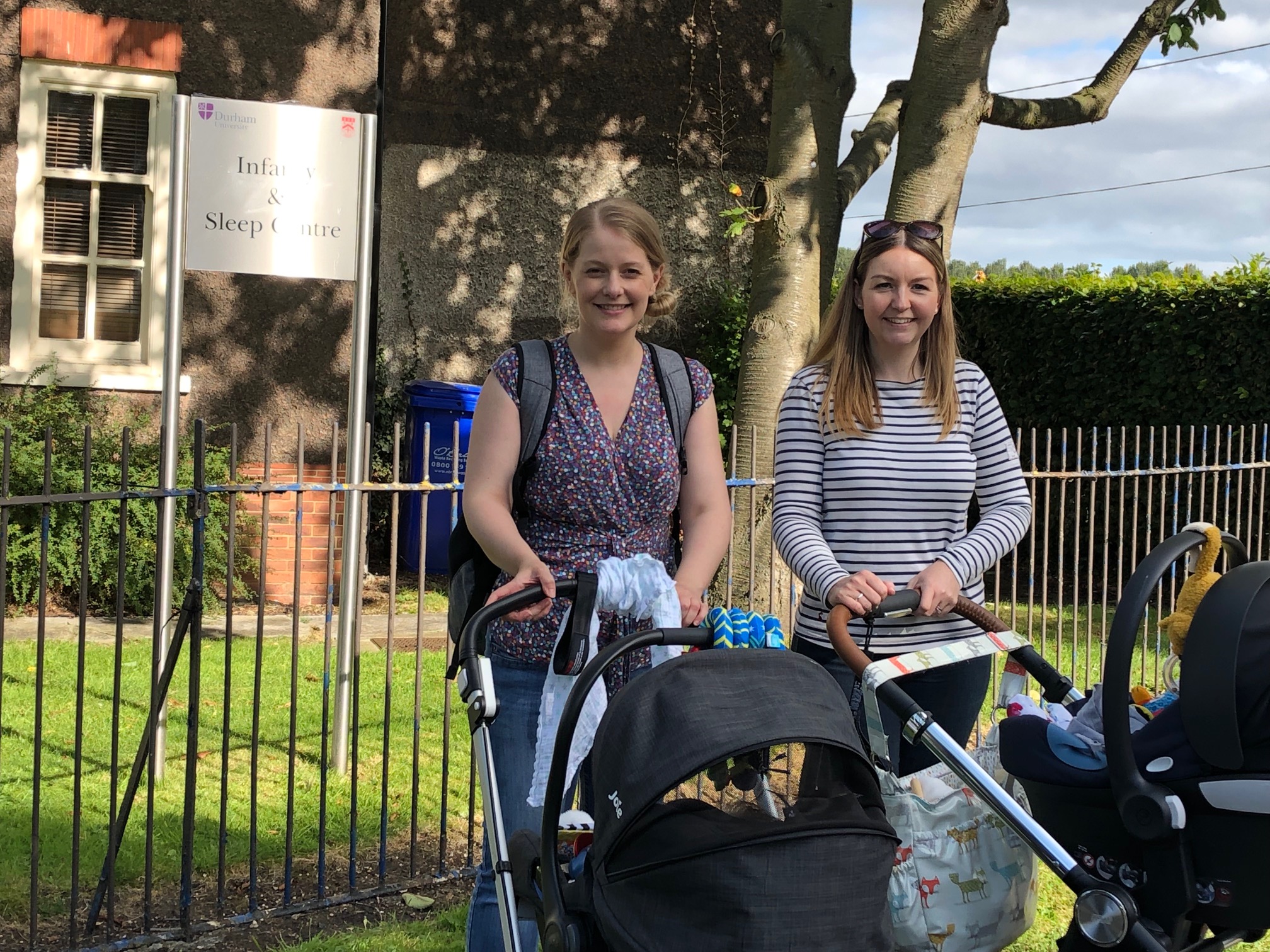 Two women and their babies outside of the Infancy and Sleep Centre