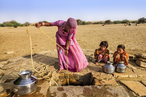 Woman and children in India at a well