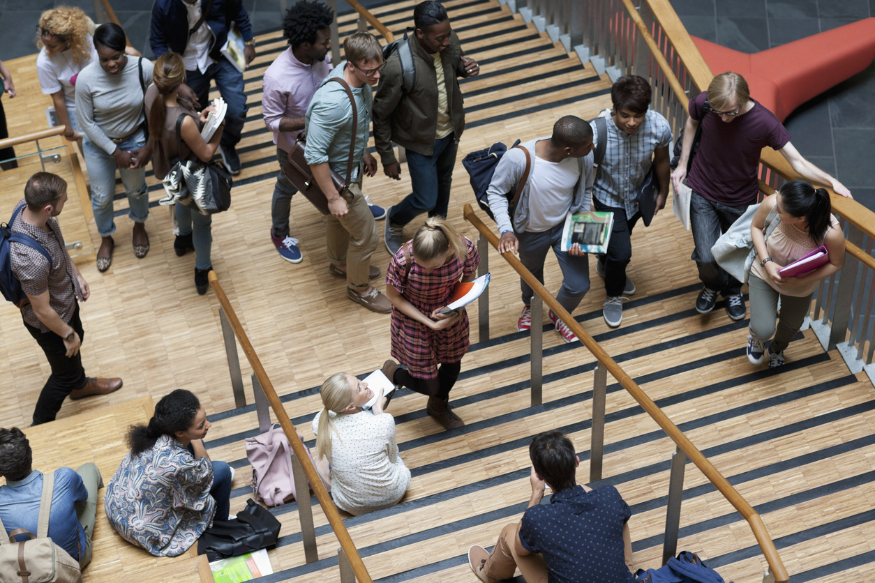 university students walking up and down stairs