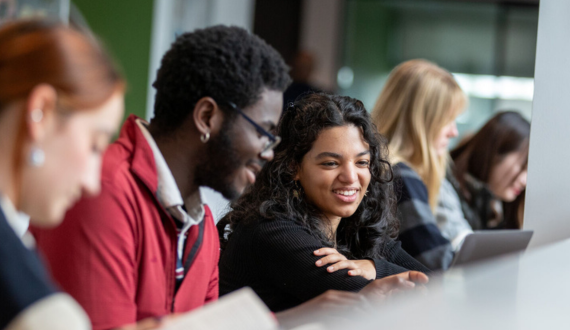 Two students looking at a laptop.